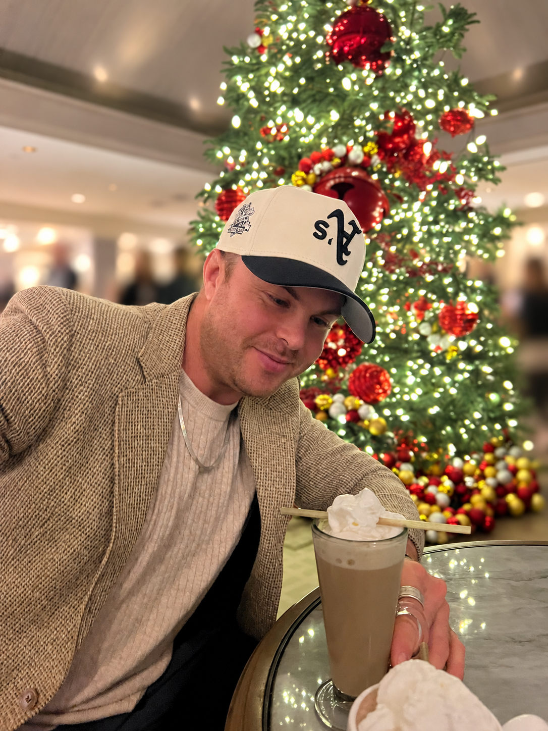 Austin Mitchell beside a decorated Christmas tree